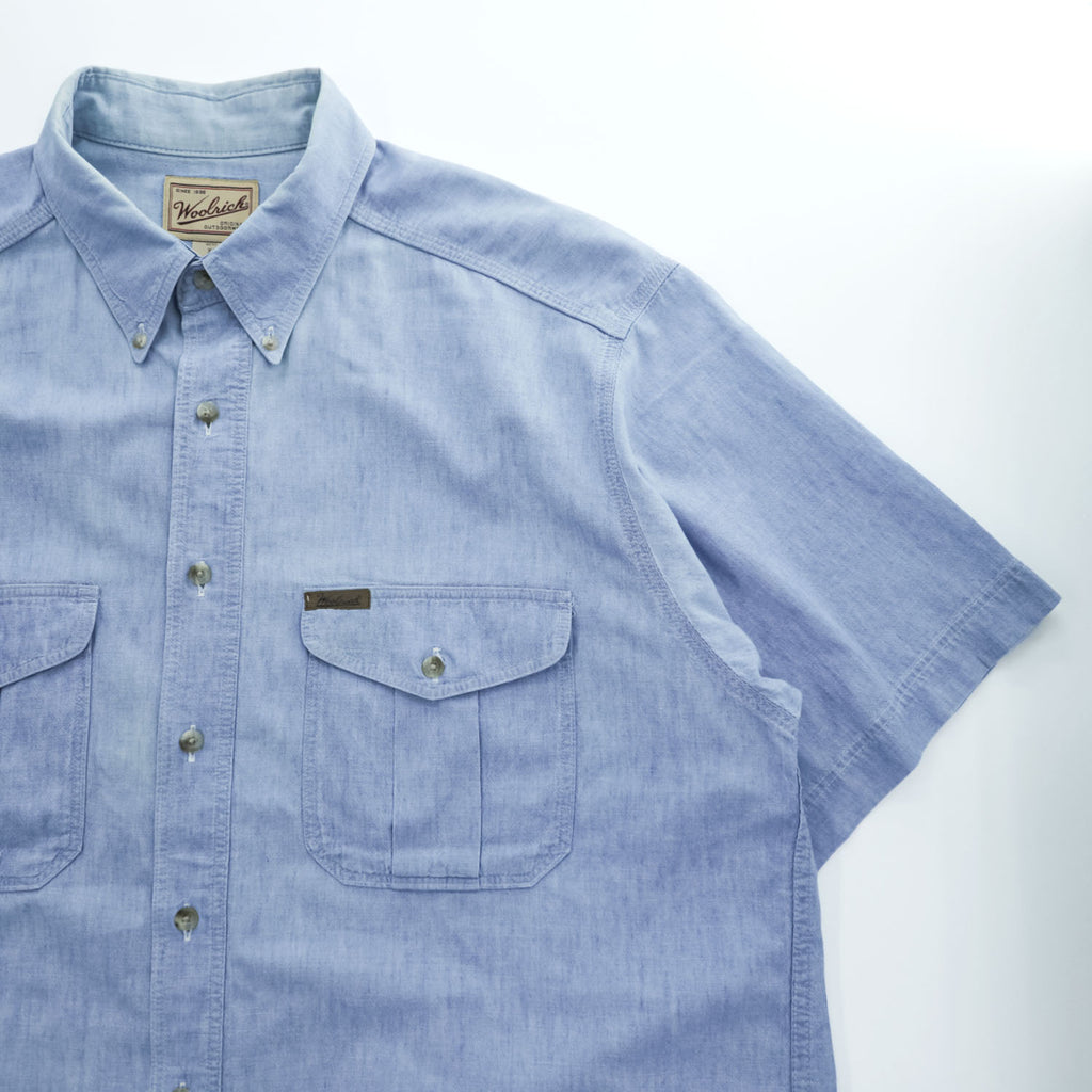 Woolrich 90s USA Made Vintage short sleeve chambray shirt light blue 100% cotton button-down chest flap pockets x2 back box pleat Made in USA XL