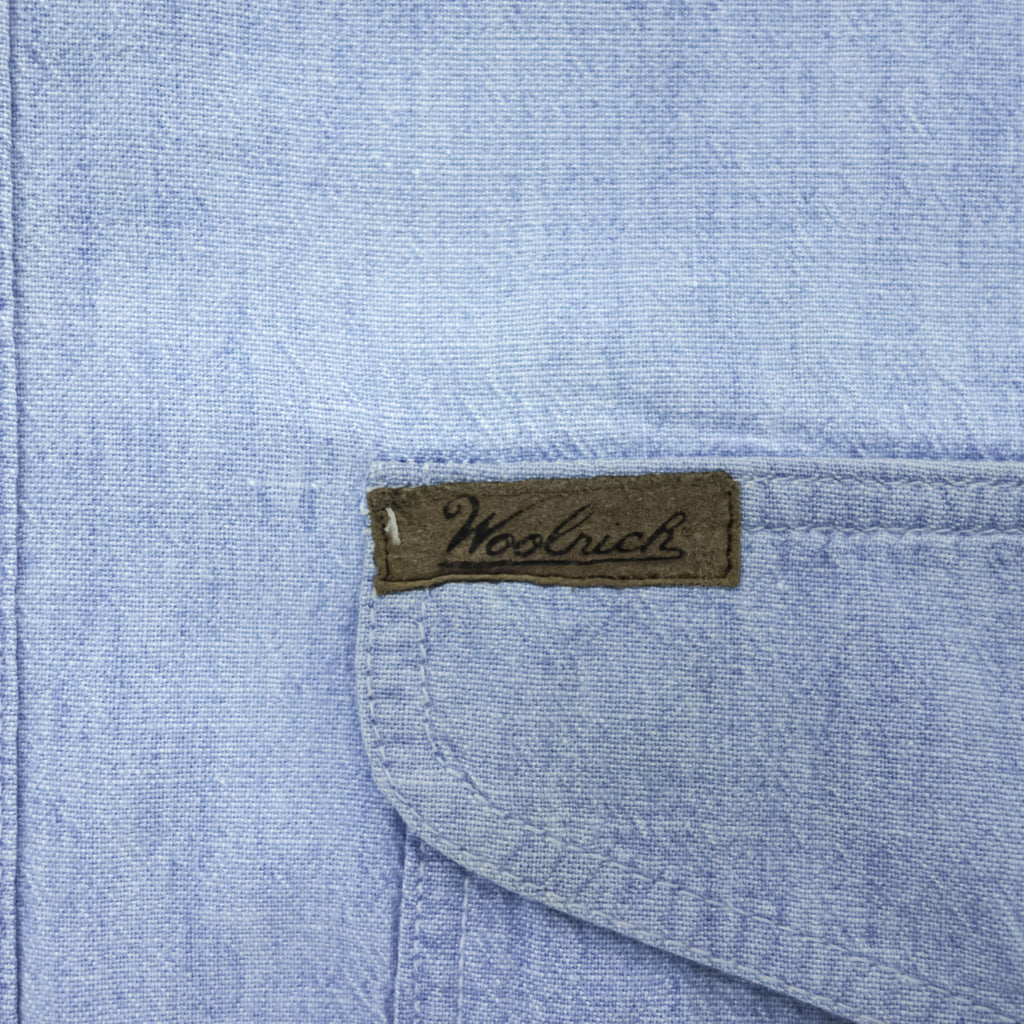 Woolrich 90s USA Made Vintage short sleeve chambray shirt light blue 100% cotton button-down chest flap pockets x2 back box pleat Made in USA XL