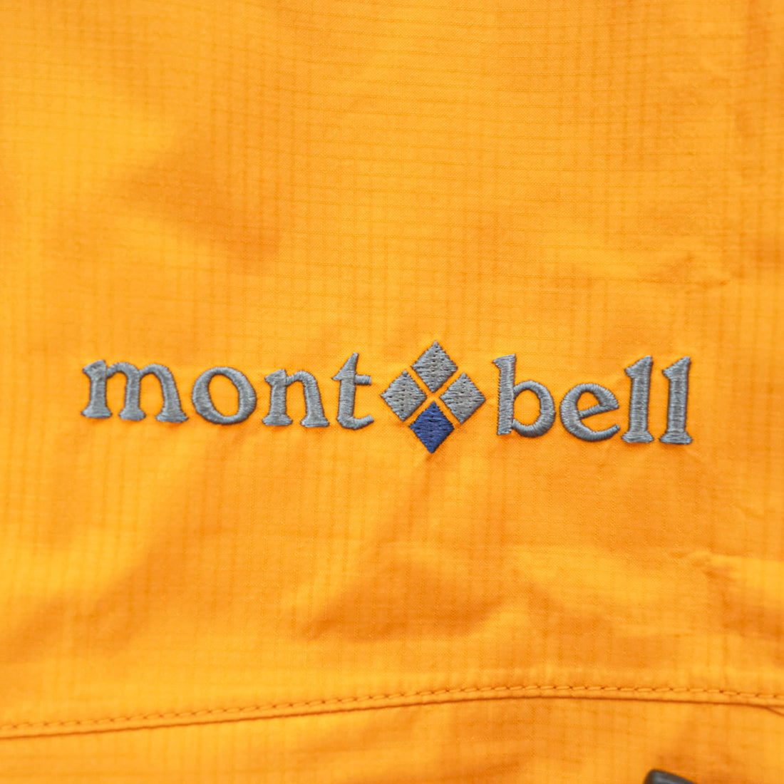 mont-bell ゴアテックス GORE-TEX 防水 マウンテンパーカー シェル レインジャケット L オレンジ ストームクルーザー ドローコード フード収納 1128256
