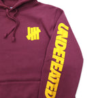 UNDEFEATED ロゴプリント プルオーバー パーカー L ピンク コットン 袖プリント